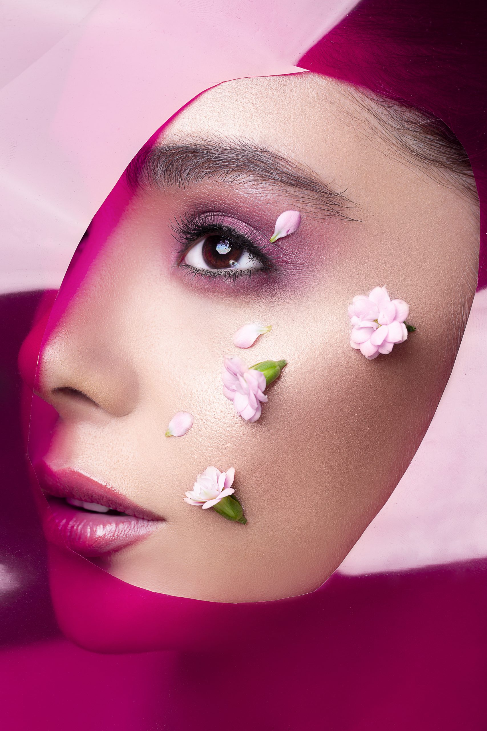 Female model wearing pink lipgloss and eyeshadow
