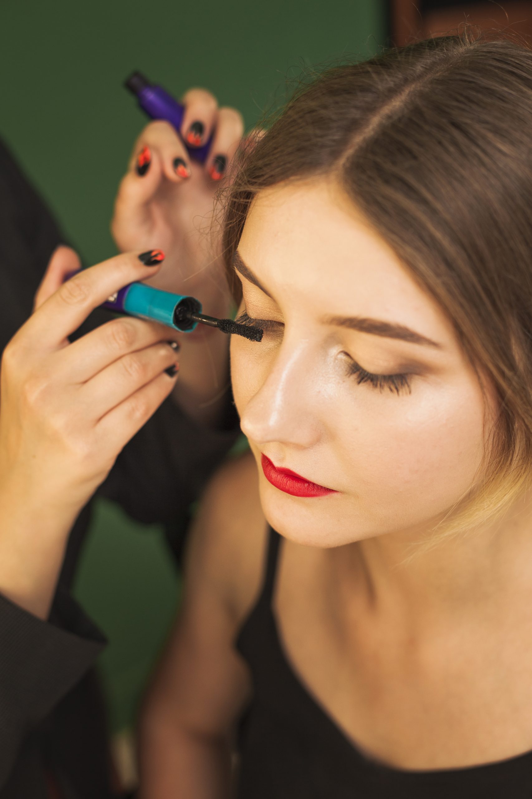 professional-woman-making-up-girl-s-eyes